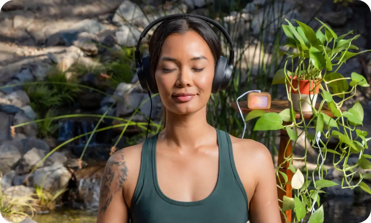 A girl meditating with Plantwave sound box